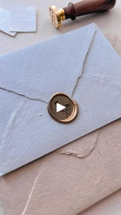 an open envelope with a wax stamp on it