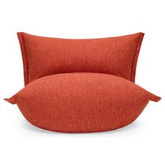 an orange pillow sitting on top of a chair