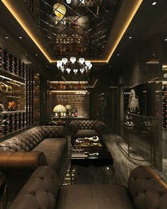 a room with couches, wine bottles and chandeliers