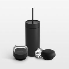 a black tumbler next to an object on a white background