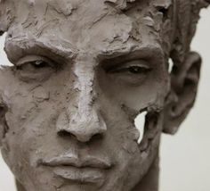 a close up of a clay sculpture of a man's face