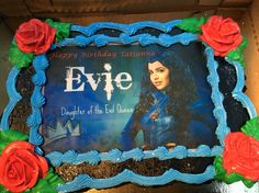 a birthday cake with the name eve on it and red roses in front of it