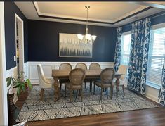 a dining room with blue walls and white trim