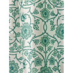 a green and white curtain with flowers on it