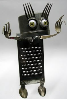 a robot made out of metal with forks and spoons