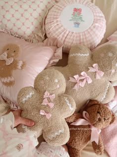 several teddy bears and pillows on a bed