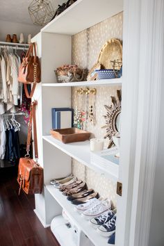 an organized closet with shoes, purses and handbags on the shelve