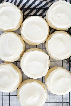 frosted cookies sitting on top of a cooling rack