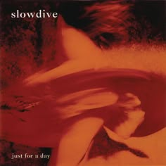 a woman laying on the ground with her hair blowing in the wind and text slowdive just for a day