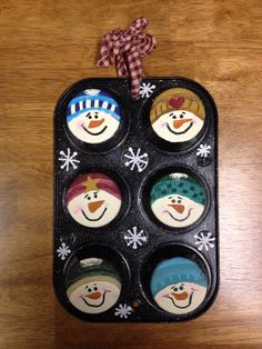 an egg carton with six snowmen painted on it