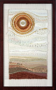 an art work with different colors and patterns on the fabric, framed in a wooden frame