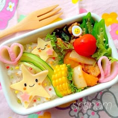 a white bowl filled with lots of food on top of a table next to utensils