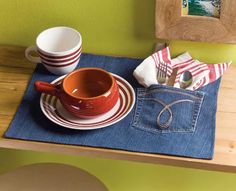 there is a cup and saucer on the placemat next to some glasses, napkins and eyeglasses