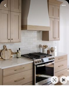 a stove top oven sitting inside of a kitchen next to wooden cabinets and counter tops