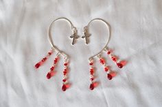 Handmade, goth ear cuffs with cross pendants🖤 -Made of silver-plated copper wire -Decorated with red, glass beads imitating blood drops -Adjustable! The wire is flexible enough so you can shape it gently if necessary. -Very easy to put on, hook over the back of your ear. No piercing is needed! -Comfortable and lightweight -Perfect for a vampire costume, halloween party, cosplay, photo session or just for everyday wear to spice up your outfit. -A great gift idea, give your loved one something special💖 All my jewelry is nickel and lead free, created only with safe to wear materials. JEWELRY CARE: -Please avoid direct contact with perfume or other chemicals. -Remove jewelry when swimming or bathing -Avoid exerting extreme pressures on jewelry to maintain its design shape -Remove when sleepi Valentine's Day Red Jewelry With Ear Wire, Red Pierced Earrings For Halloween, Vampire Costume Halloween, Red Gothic Earrings For Pierced Ears, Adjustable Red Gothic Jewelry, Vampire Jewelry Inspire Uplift ⭐, Vampire Earrings, Earrings Goth, Blood Drop