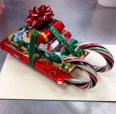 candy canes wrapped in foil and tied with ribbons