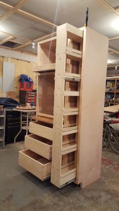 an unfinished storage cabinet in a garage