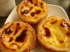 three mini cheese pies sitting on top of a white plate