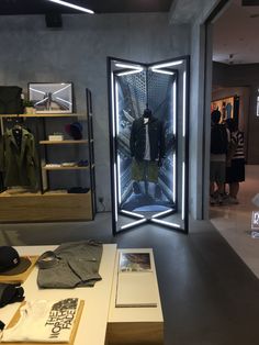 a clothing store with an open door and clothes on display in front of the window