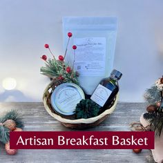 an image of a basket with some food in it and the words artisan breakfast basket