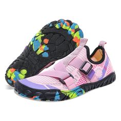 a pair of pink and black shoes with multicolored flowers on the soles