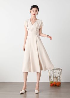 "Cool and comfortable for hot summer days, this beige dress is elegant and stylish.    It is a wonderful wardrobe staple that's a timeless classic you'll wear again and again. All our items are Tailored and Handmade and Made to Order ,I can make Any Size . I design new styles every week, please collect my store. I believe that you will meet your favorite styles. ★★FEATURES Polyester fabric Two side pockets Back zipper closure V neck Short sleeve Midi dress Casual dress Beige dress Simple dress P Cream A-line Maxi Dress For Summer, Casual Cream V-neck Midi Dress, Beige V-neck Dress For Summer, Feminine Midi Dress With Notched Neckline For Summer, Feminine Summer Midi Dress With Notched Neckline, Casual Beige Midi Dress With V-neck, Spring Solid Color Midi Dress With Notched Neckline, Spring Midi Dress With Notched Neckline, Feminine Summer V-neck Dress With Notched Neckline