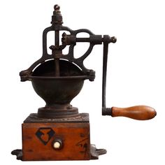 an old fashioned coffee grinder with wooden handle