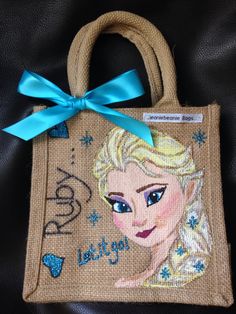 a handbag with a frozen princess design on the front and blue ribbon around it