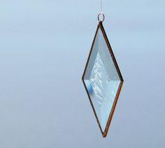 a wind chime hanging from a wire with snow covered mountains in the back ground