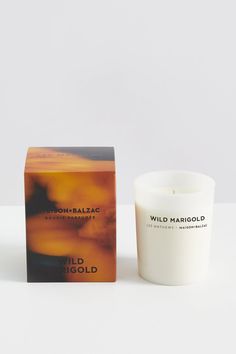 a candle sitting next to a box on a table