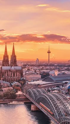 an aerial view of the city and its cathedrals at sunset, with a bridge crossing over it