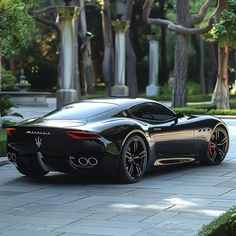 a black sports car is parked on the street