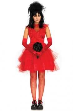 a woman in a red dress and black hair is standing with her hands on her hips