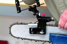 a close up of a person holding a skateboard on a rail with chains attached to it