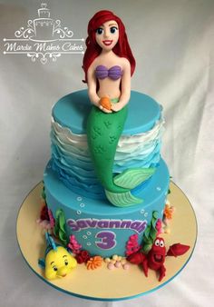 a birthday cake with a little mermaid on top