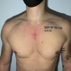 a shirtless man with a cross tattoo on his chest and the words xxiv vivi xixi written in roman numerals