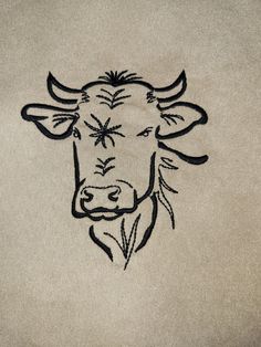 an embroidered bull head on a white background