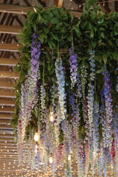 purple and blue flowers hanging from the ceiling