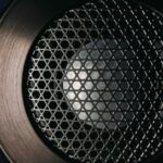 a close up view of a speaker with lights on it's side and in the center