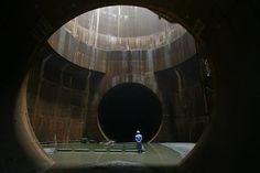 a man standing in the middle of a tunnel