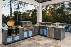 an outdoor kitchen with grill and sink