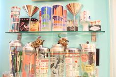 there are many different items on the shelf in this room, including cans and cups