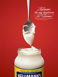 a spoon full of milk being lifted from a jar with the word hellman's on it