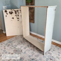 an old cabinet is sitting on the floor in front of a wall with peeling paint