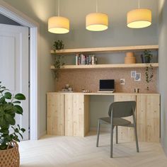 a room with a desk, chair and potted plant