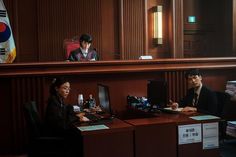 two people sitting at a desk in an office