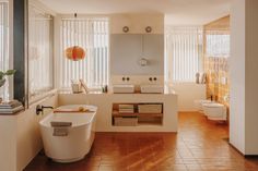 a bathroom with a tub, sink and toilet in it's center wall is shown