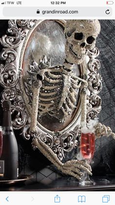 a skeleton holding a wine glass in front of a mirror