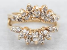 two gold rings with white diamonds on each one and the other in different shapes, sizes and colors