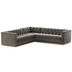 a large gray sectional couch sitting on top of a white floor